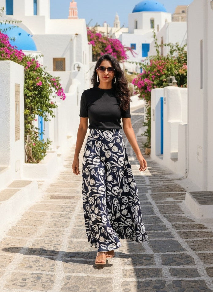 Woman walking on a picturesque street with blue domes and white buildings in Santorini, Greece.